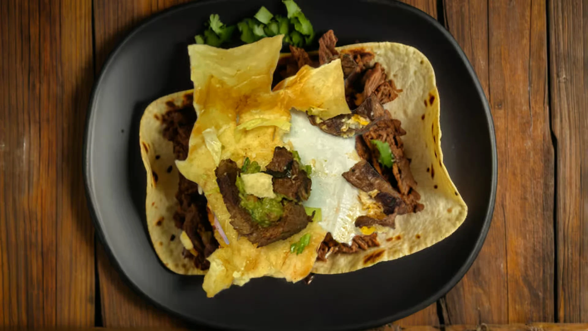 Chimichanga - A crispy deep-fried burrito filled with seasoned beef or chicken, topped with sour cream, guacamole, and fresh salsa.