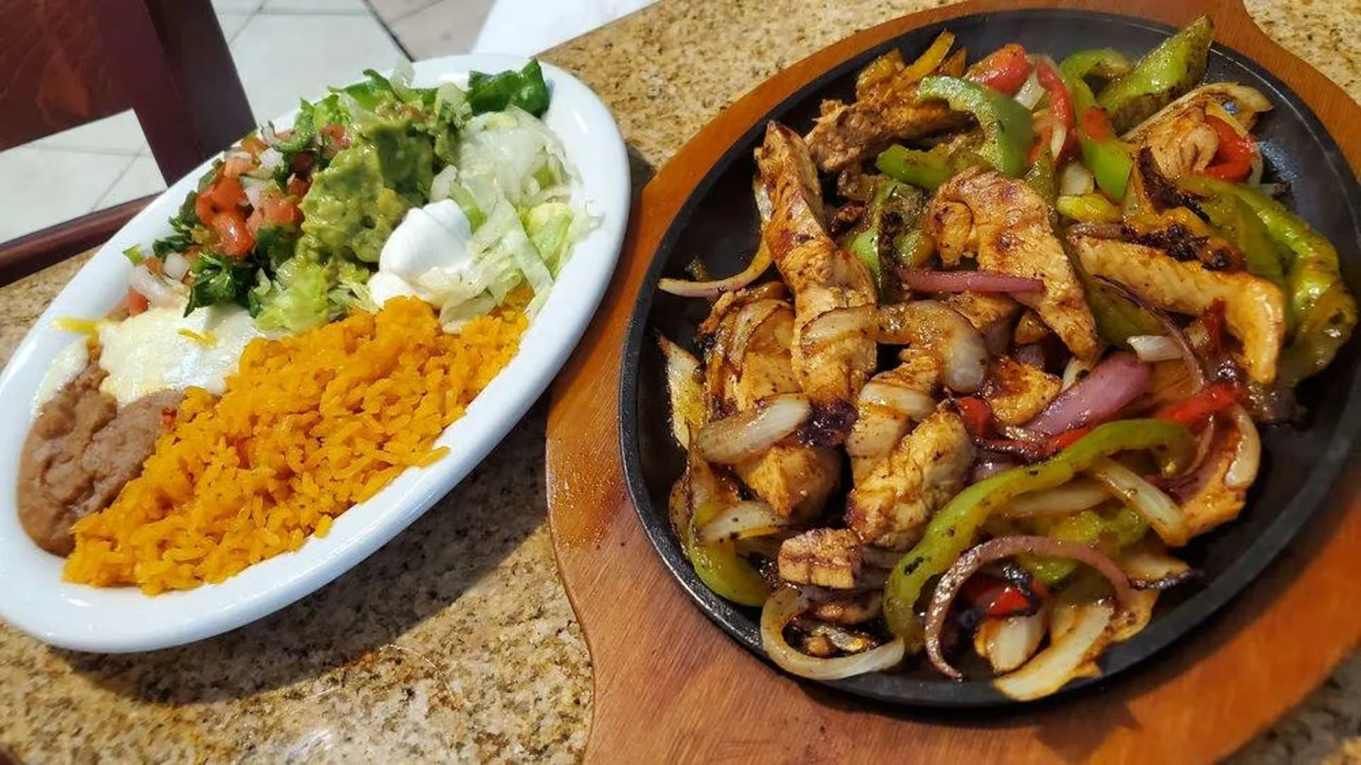 Fajitas - Sizzling grilled steak or chicken with peppers and onions, served with tortillas